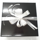 Black gift box with a white ribbon