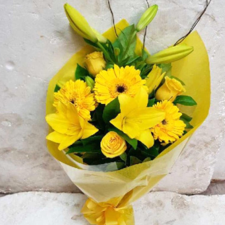 Florist Choice Bouquet of yellow flowers including lilies, yellow roses and gerberas